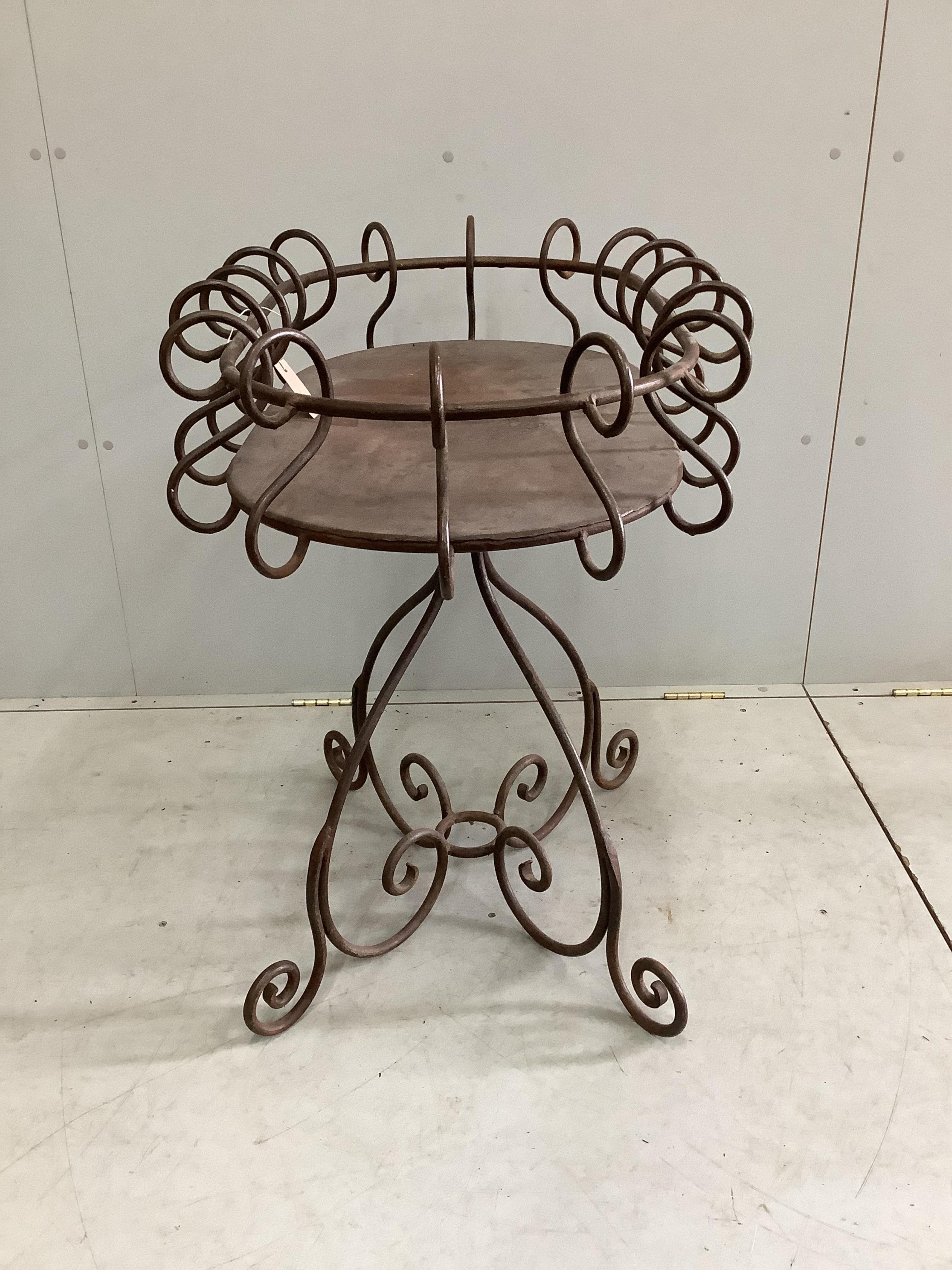 A wrought iron oval centre table, width 88cm, depth 60cm, height 82cm. Condition - fair to good